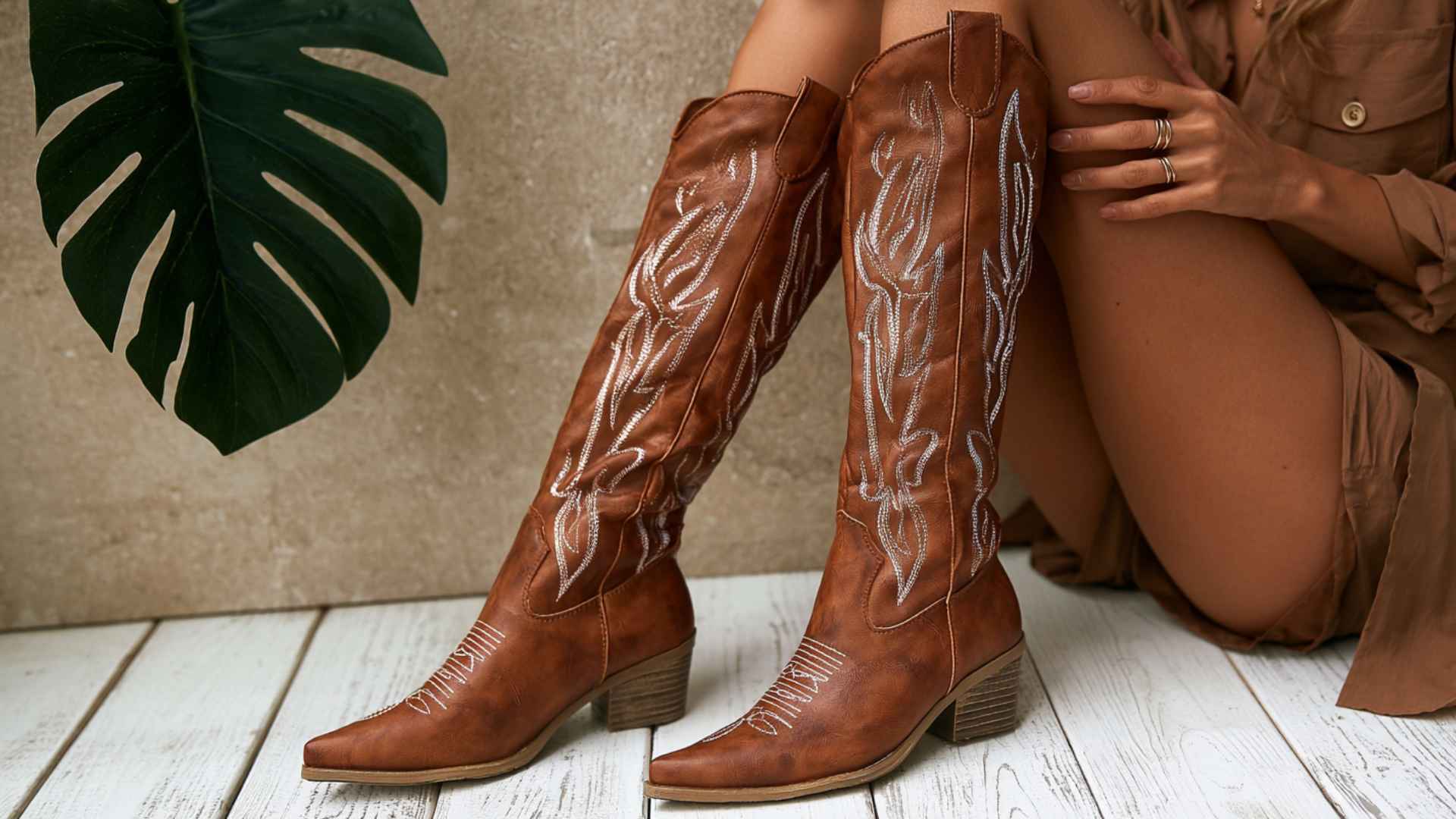 Brown classic western cowboy boots with tall embroidered shafts and pointed toes styled for traditional riding wear