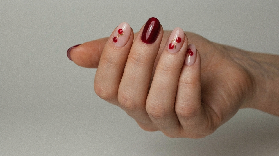 Rounded nails with deep cherry red magnetic polish and detailed three dimensional cherry designs