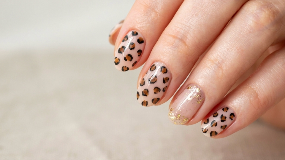 Rounded nails with delicate animal print accents creating a nail design