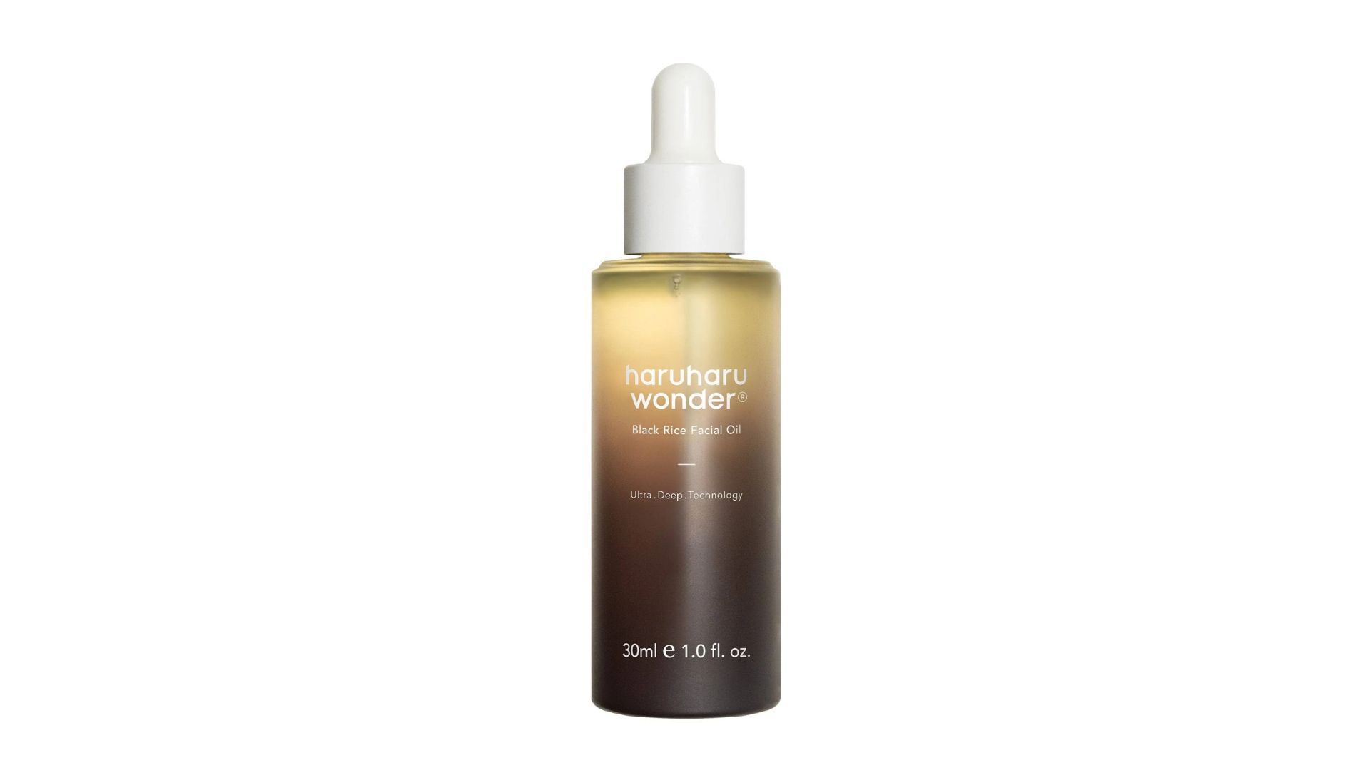 Haruharu Wonder Black Rice Facial Oil in a tall gradient brown and gold glass bottle with white dropper on white