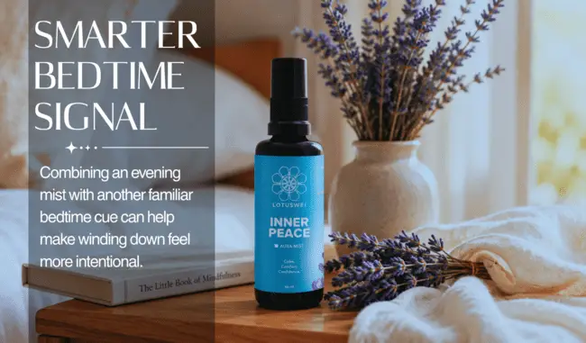 Blue bottle of aromatherapy mist beside lavender in cozy bedroom setting
