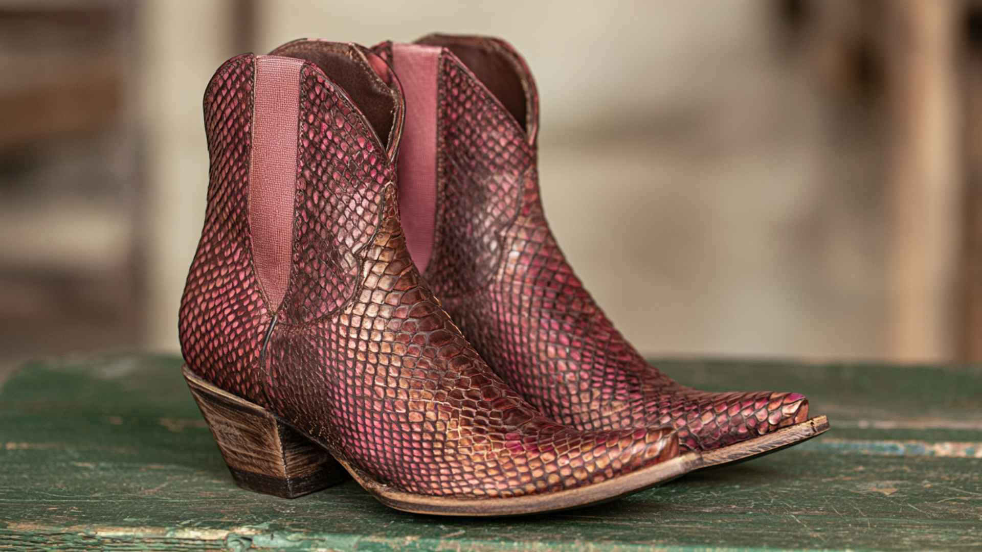 Pink exotic leather cowboy boots with textured snake pattern and pointed toes for unique western style