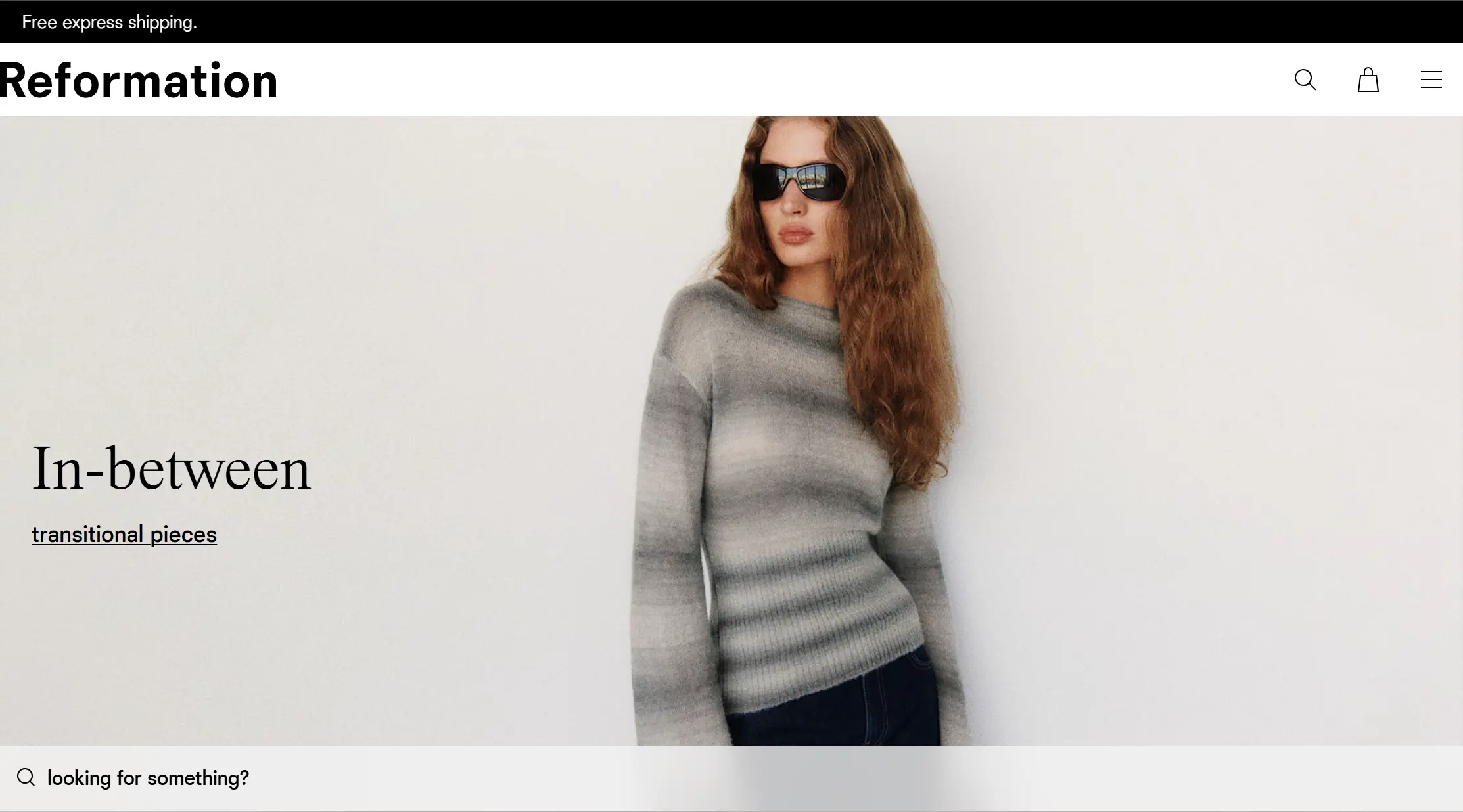 Reformation homepage banner featuring a model in a gradient knit sweater and sunglasses.
