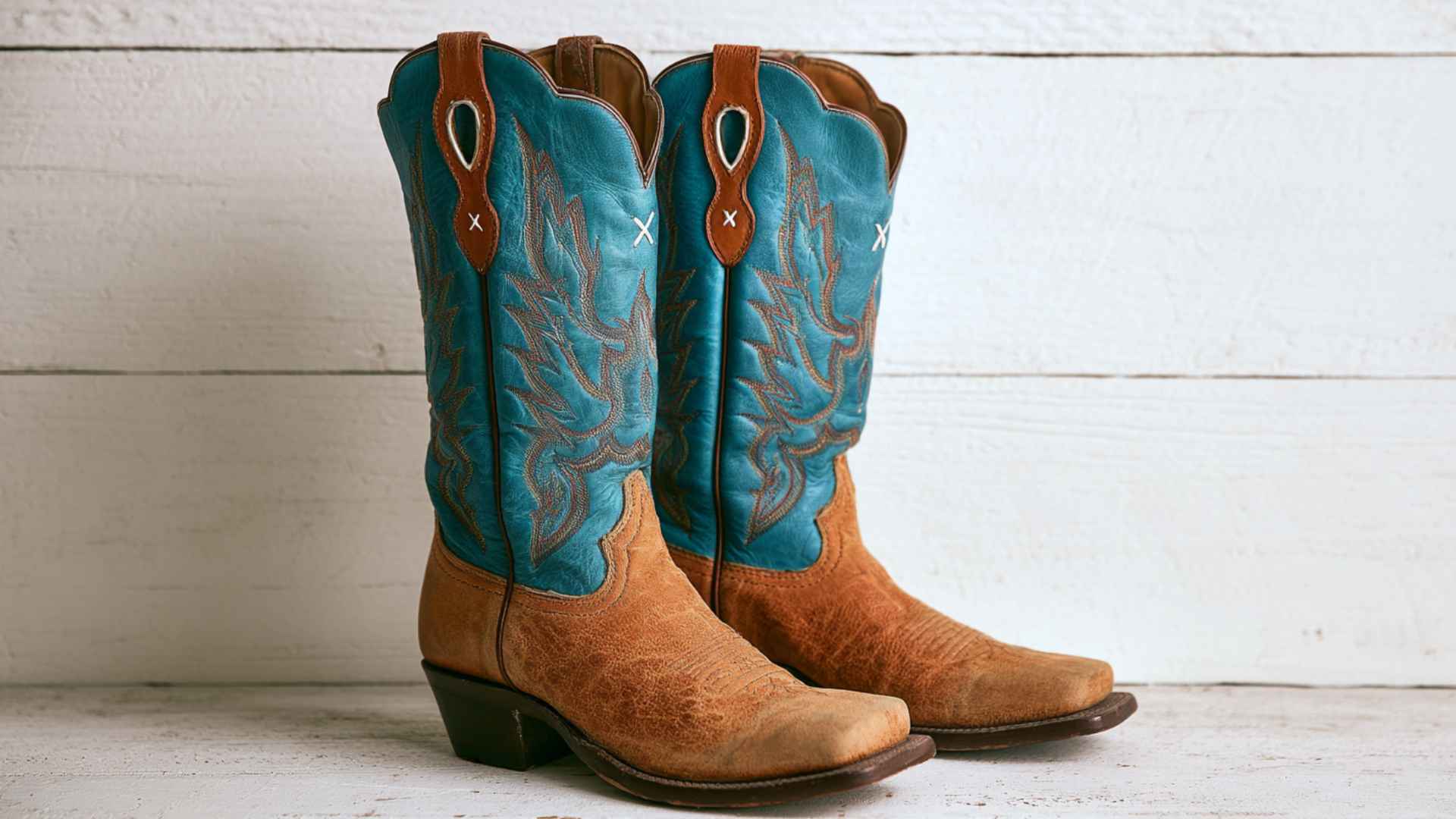Tall blue and brown stockman cowboy boots with decorative stitching and traditional western riding design