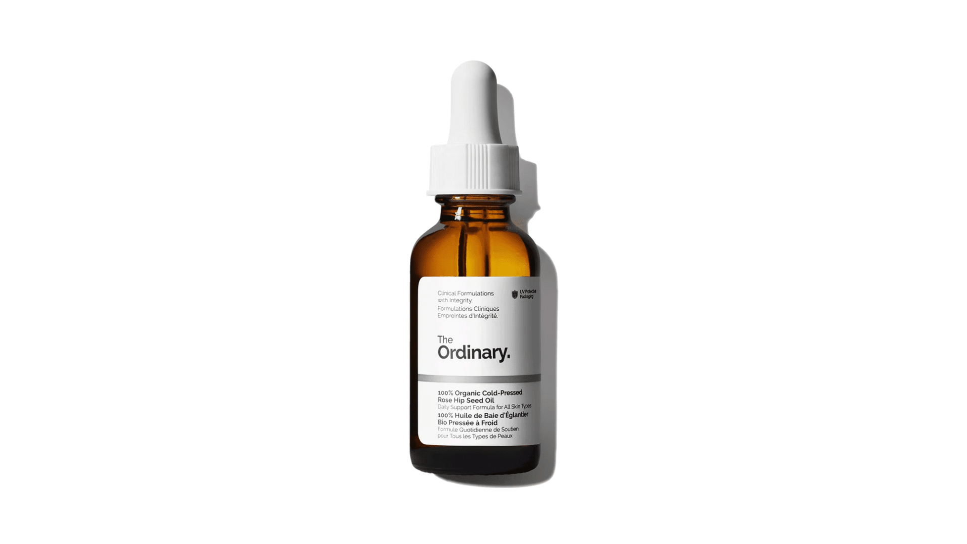 The Ordinary rose hip seed oil bottle with amber glass packaging placed on a clean white background showing skincare product details