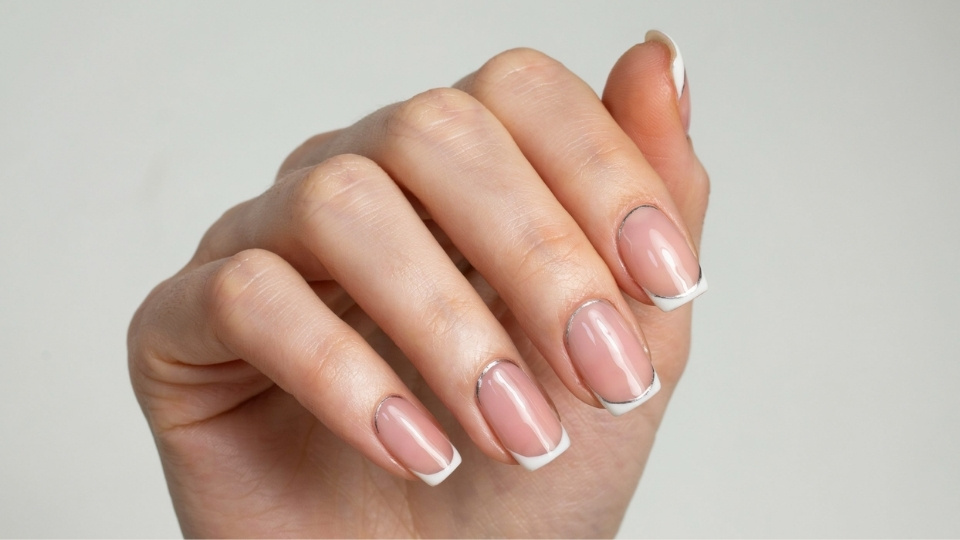 Close up hands showing square shaped nails with crisp edges, smooth finish, and elegant salon manicure design
