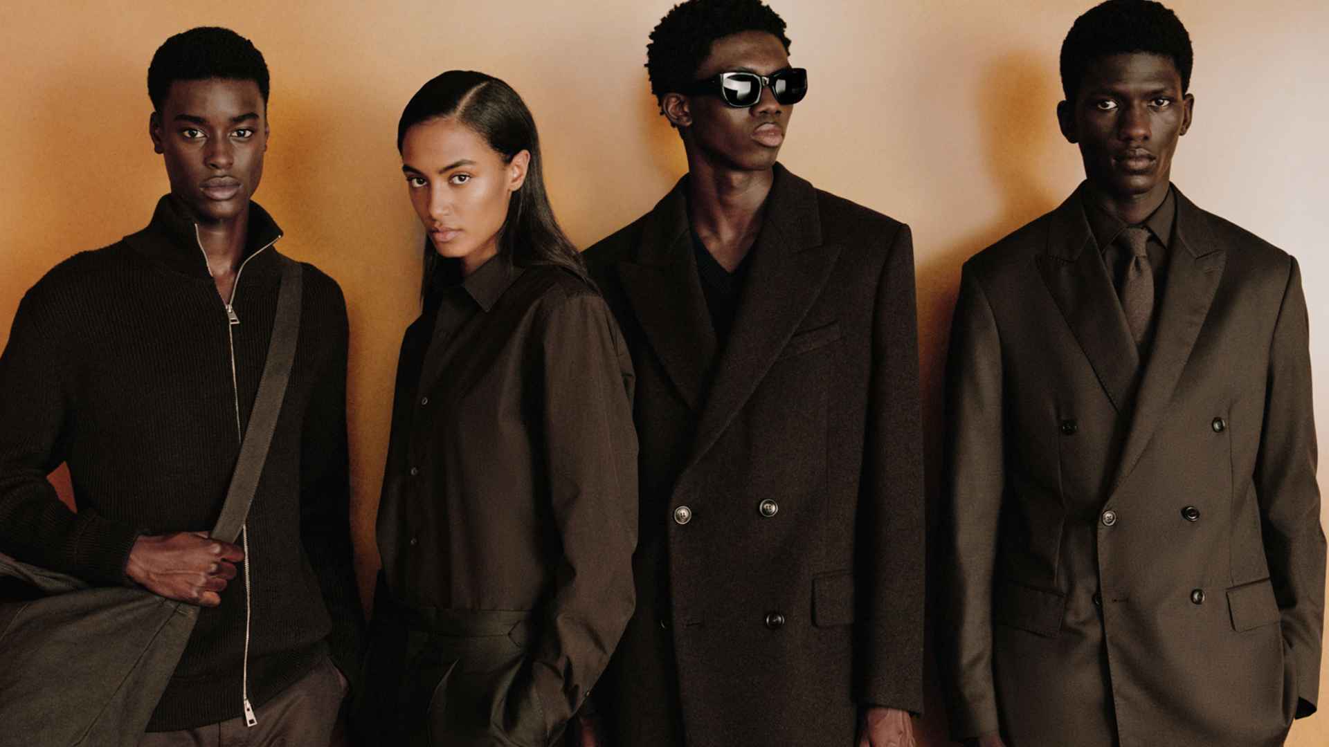 Zara clothing collection display showing three models in patterned dresses and stylish outfits from a contemporary fashion campaign setting