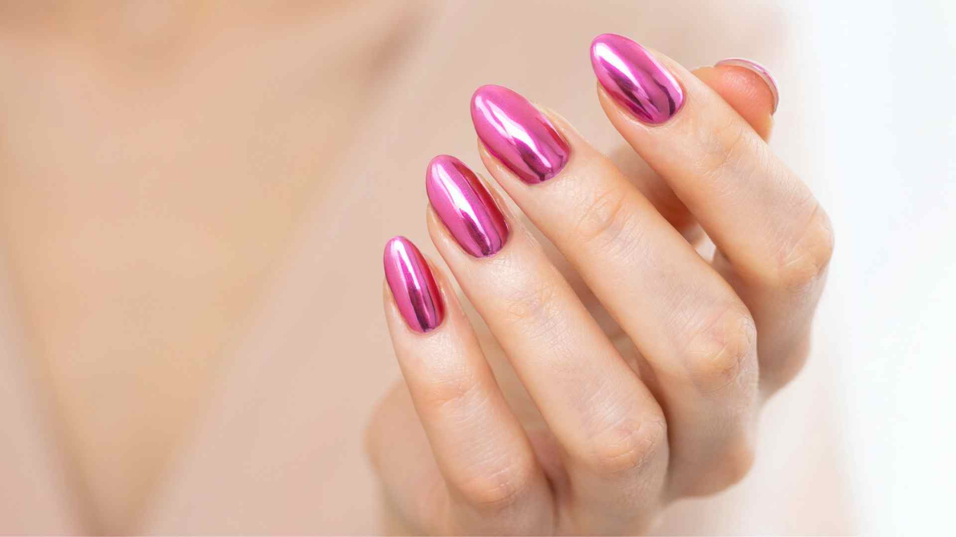 Hot pink chrome nails showing reflective metallic shine with a bright neon finish for summer manicure ideas