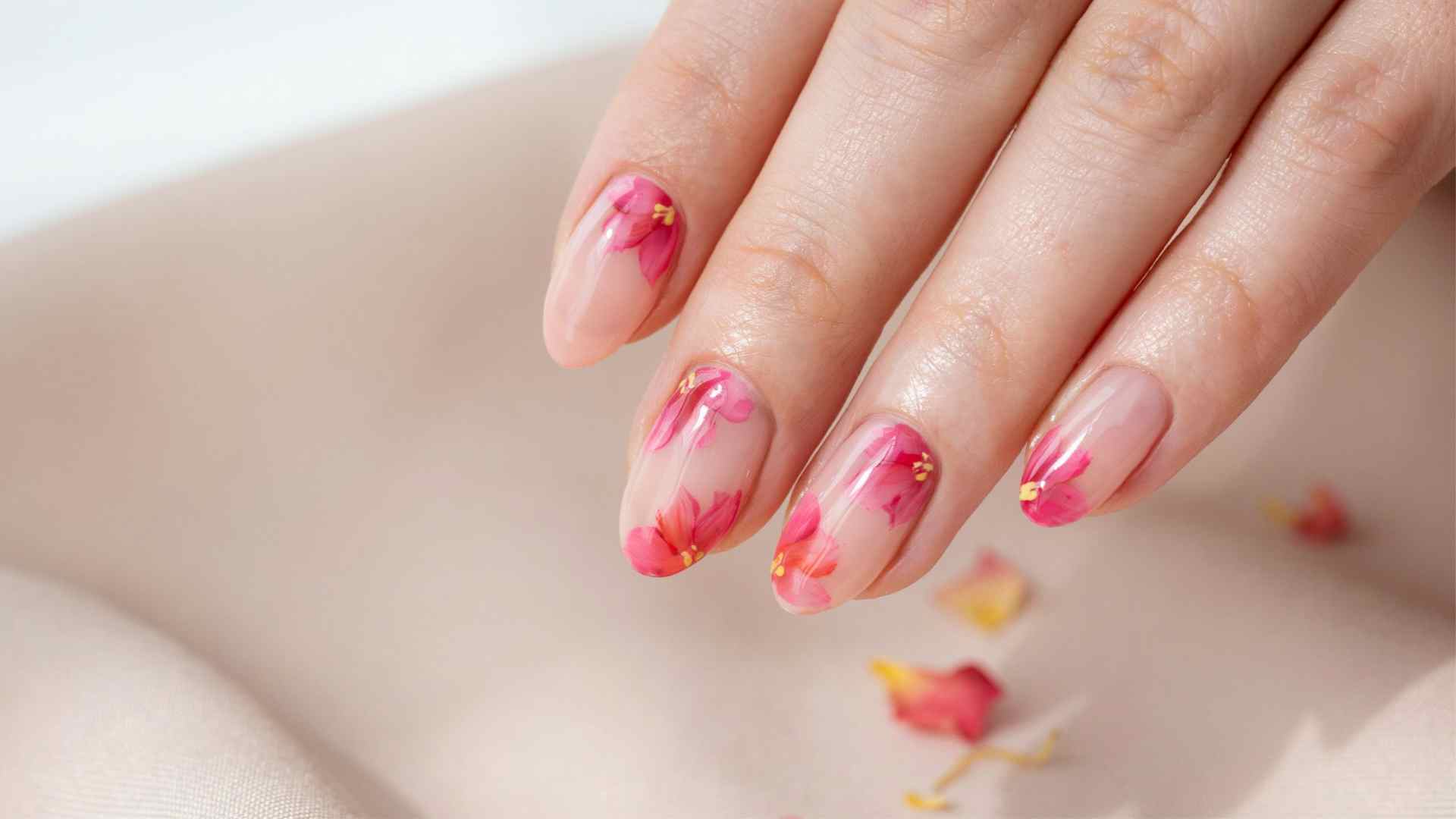 Pink lemonade blooming gel nails featuring neon pink coral and yellow blended summer nail art