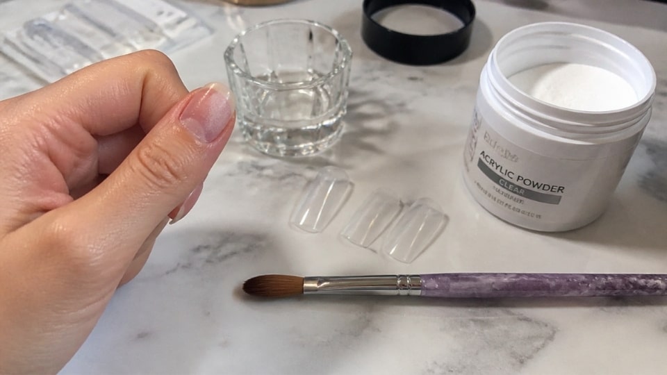 Acrylic liquid and powder used for creating a strong base during fake nail application at home