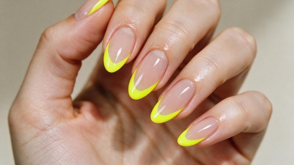 Almond nails with neon yellow French tips and glossy colorful manicure details