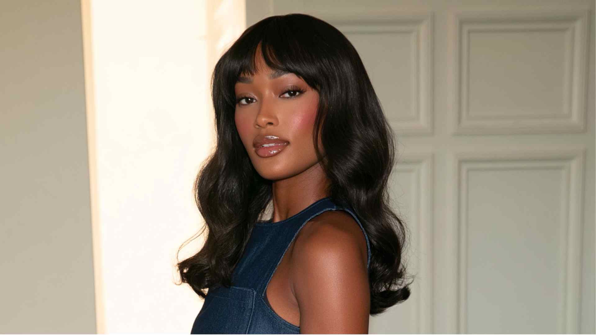 Grunge layered haircut with short baby bangs, choppy ends, and textured movement