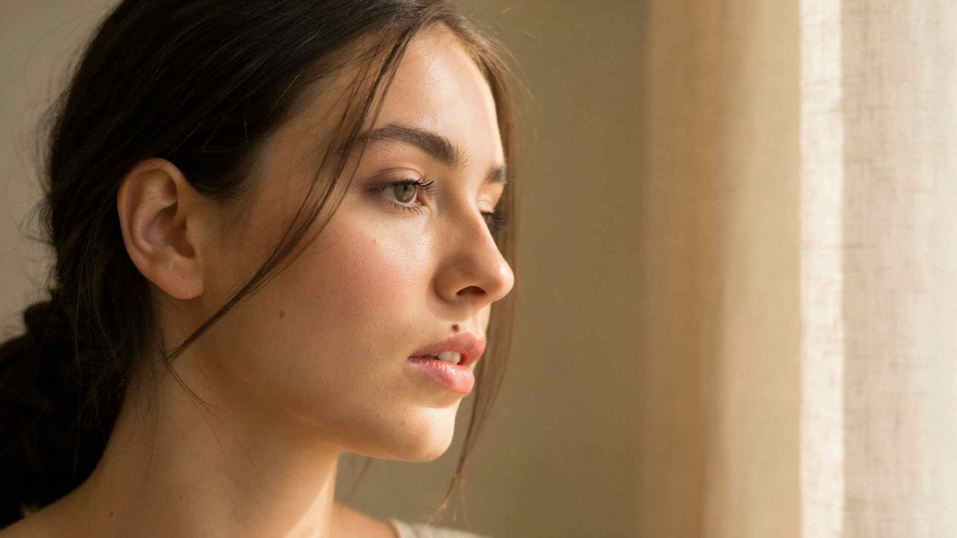 Close up portrait of a woman with a natural beauty mark near her lip