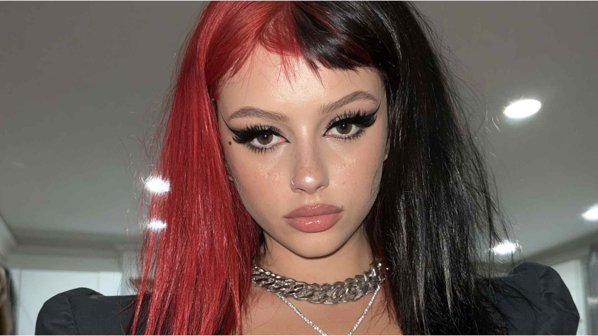 Short layered alternative haircut with contrasting black and red color