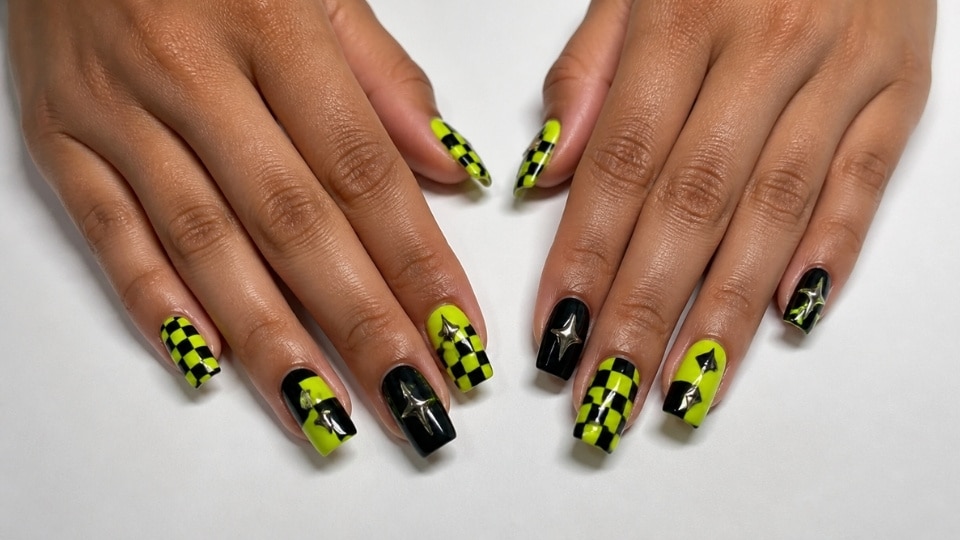 Neon yellow checkerboard nails with black patterns and bold graphic manicure design
