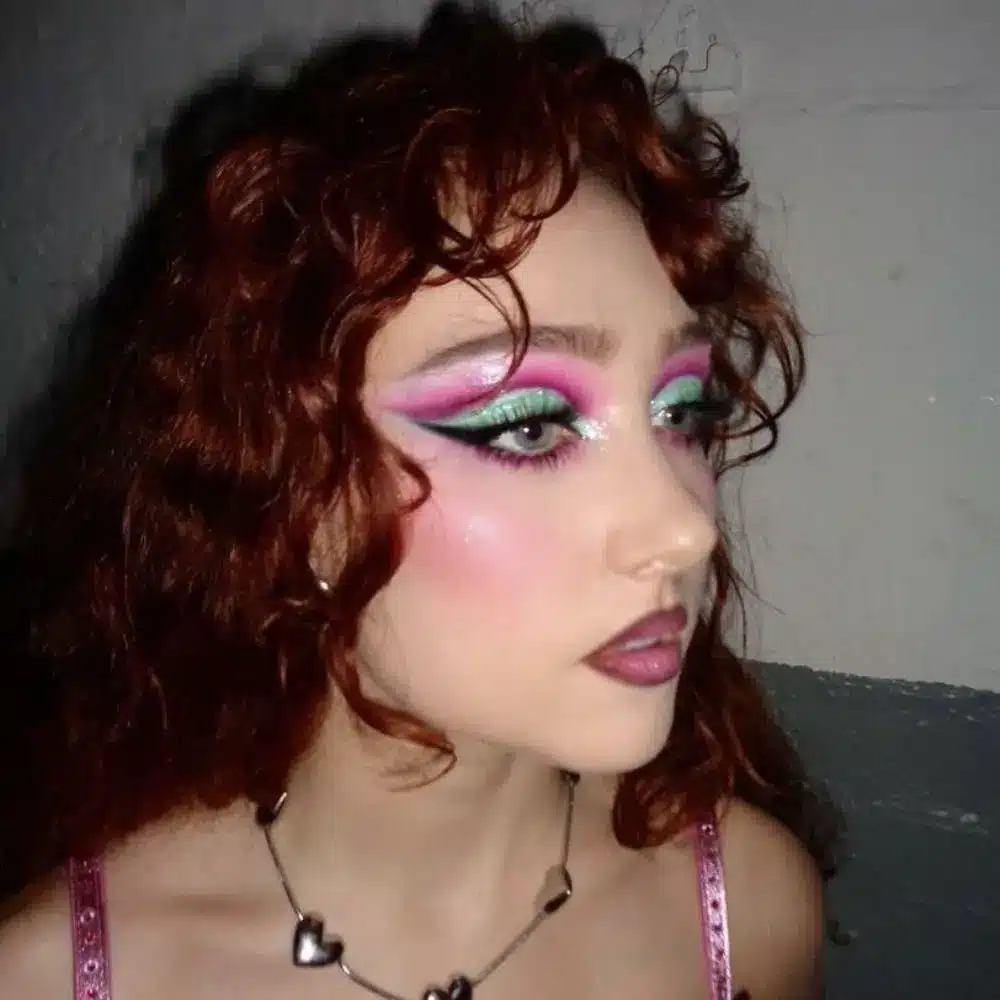 Chappell Roan makeup with vivid color blocked eyeshadow, bold graphic liner, dramatic lashes, and a contrasting lip