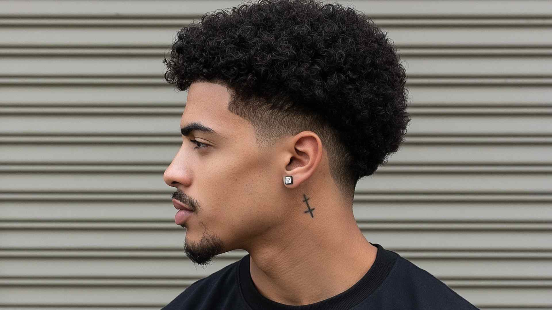 Coily tapered haircut with closely tapered sides and a full textured top