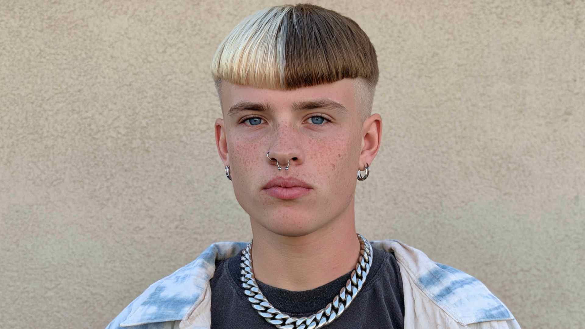Gender-neutral short alternative haircut with textured layers and flexible styling