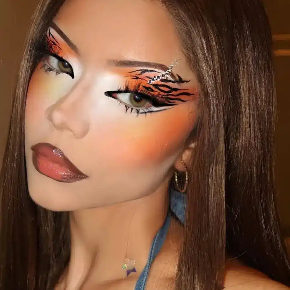 Graphic liner makeup with sharp floating black shapes, clean geometric edges, a smooth base, and neutral toned lips