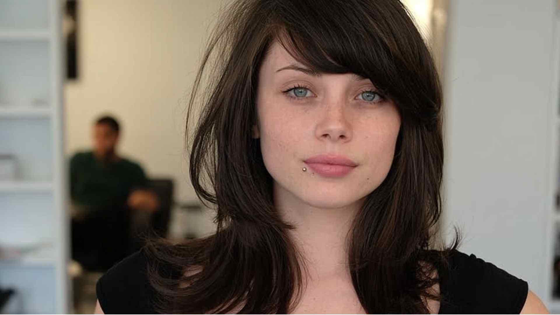 Layered grunge hair styled with a deep side part and loose ends