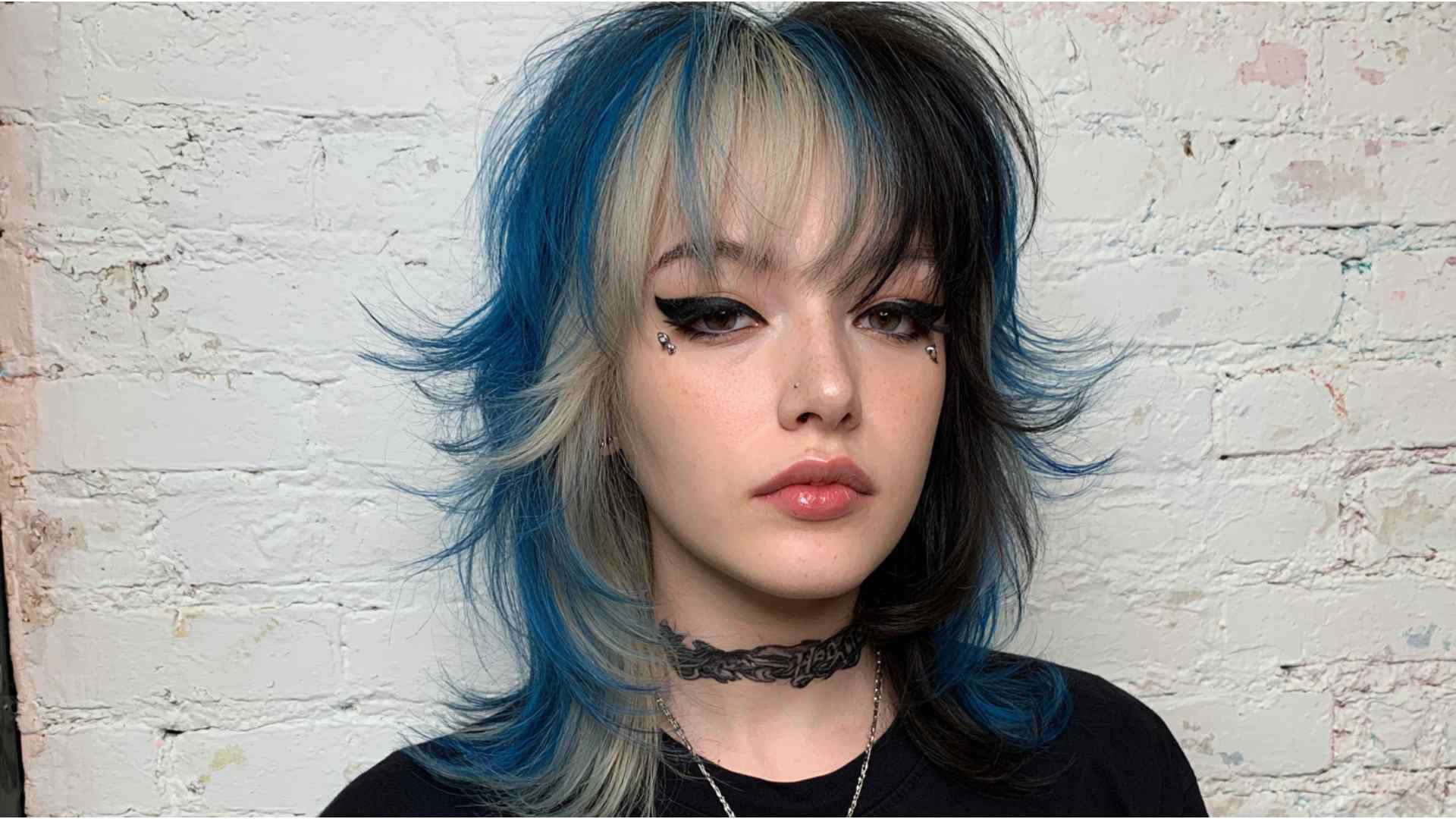 Layered grunge hair with soft curtain bangs framing the face