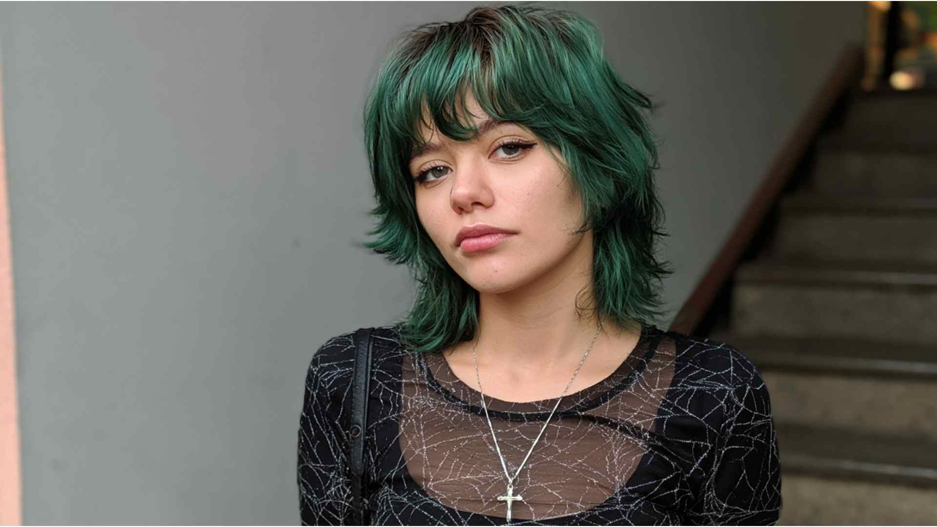 Grunge wolf cut with short crown layers, long ends, and wispy bangs