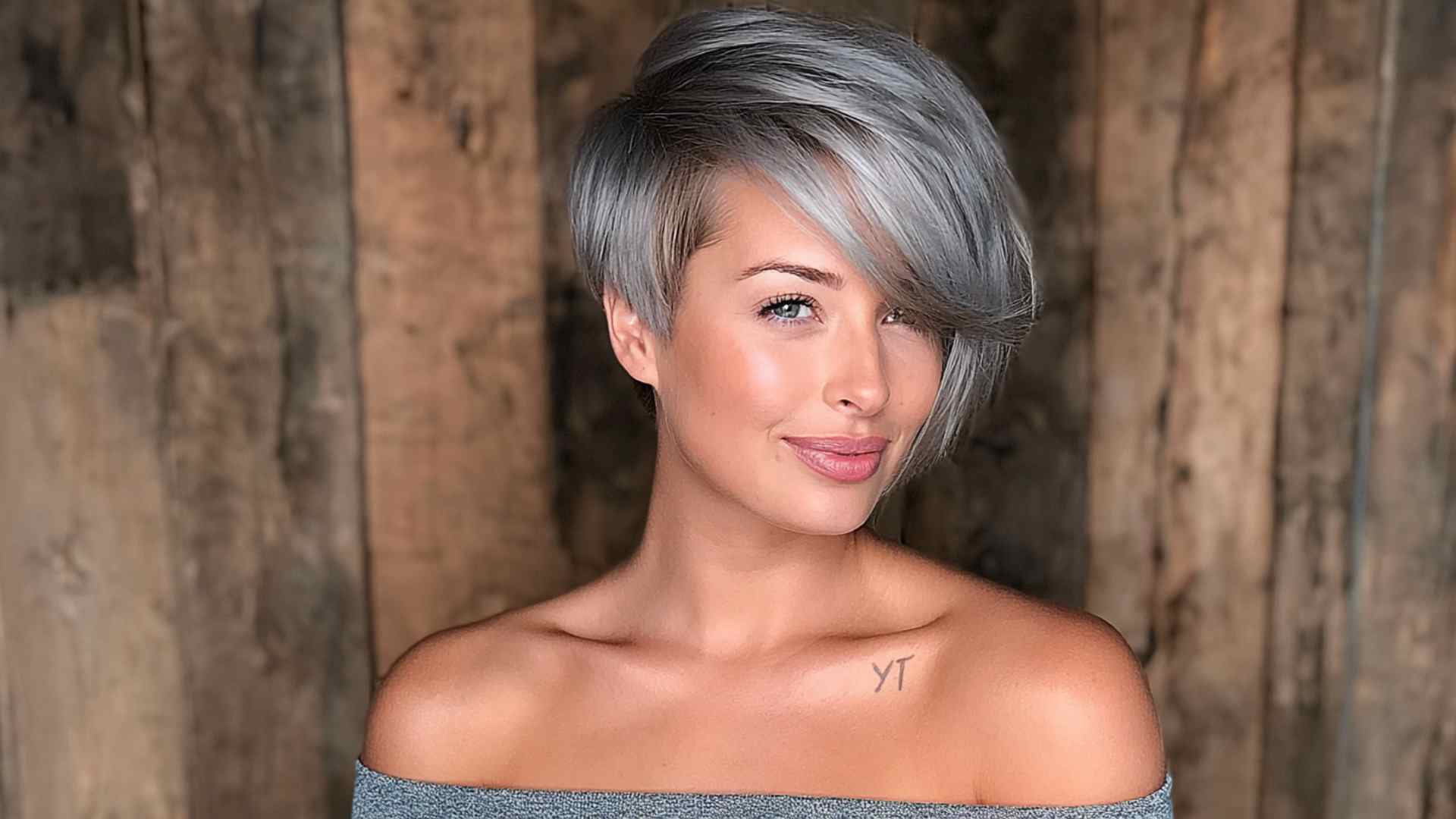 Short pixie haircut with a long sweeping fringe across the forehead