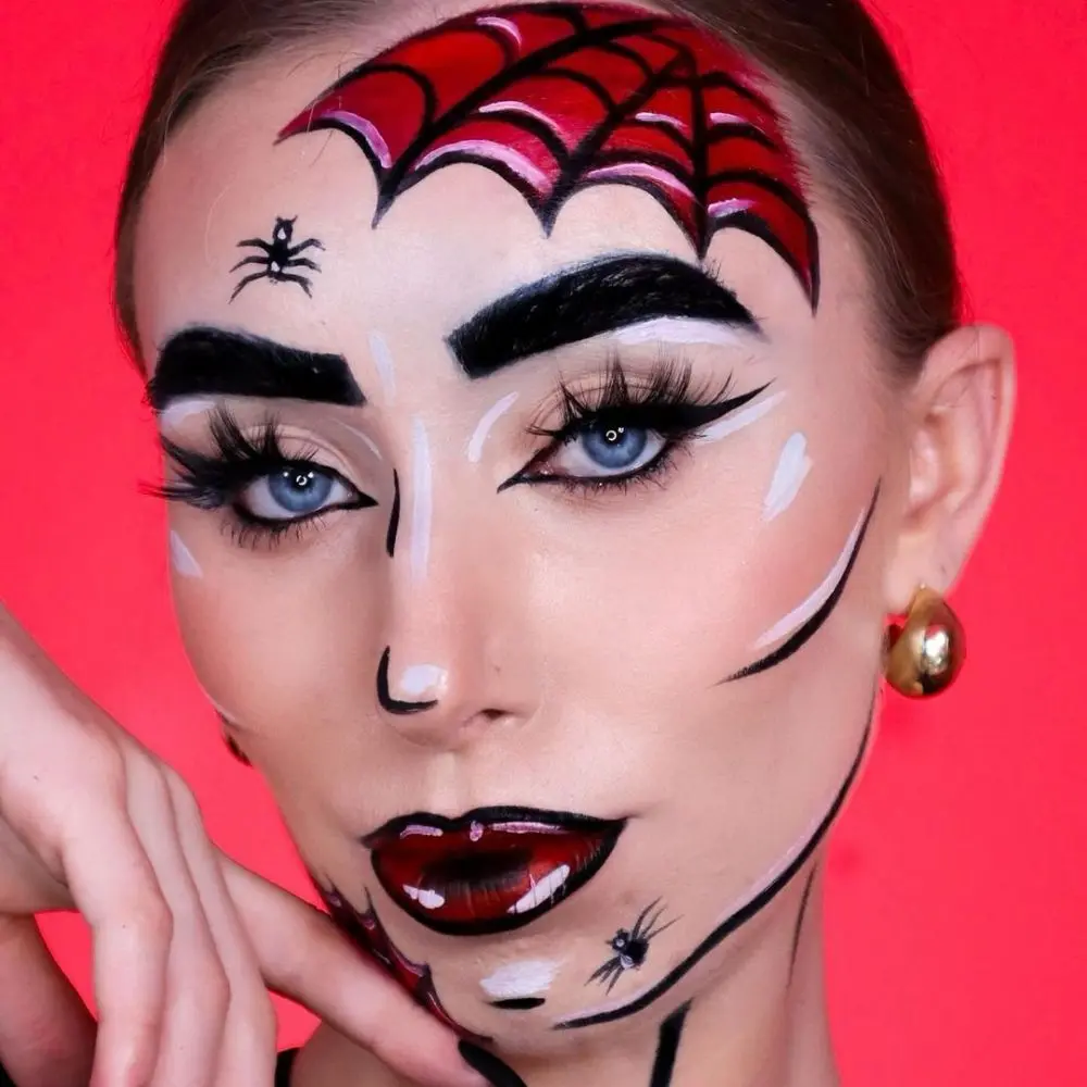 Madame Web makeup with pale skin, icy blue and silver eyeshadow, a white inner corner liner, and glowing cheekbones
