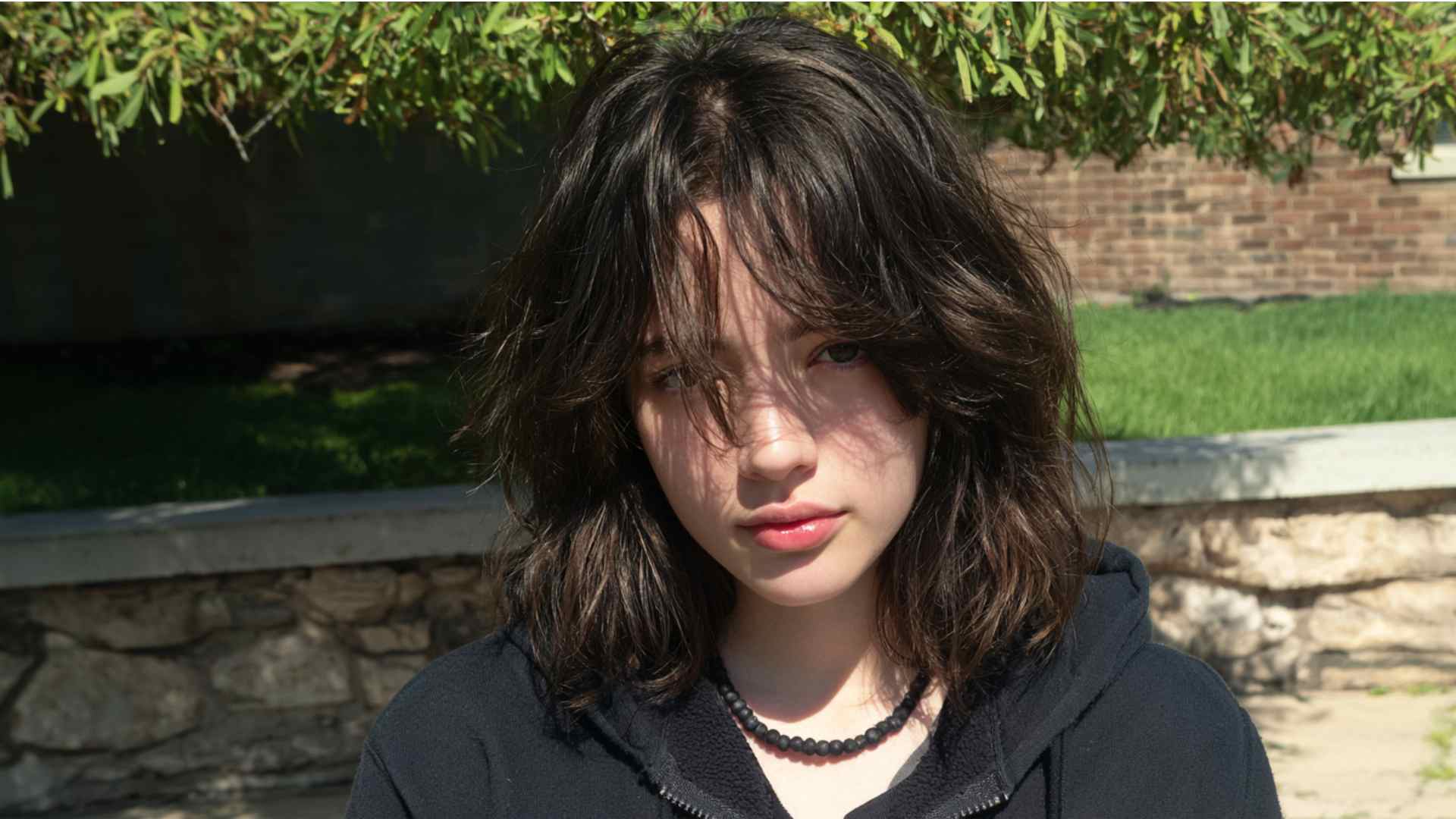 Short cropped grunge haircut with tousled layers and volume at the crown