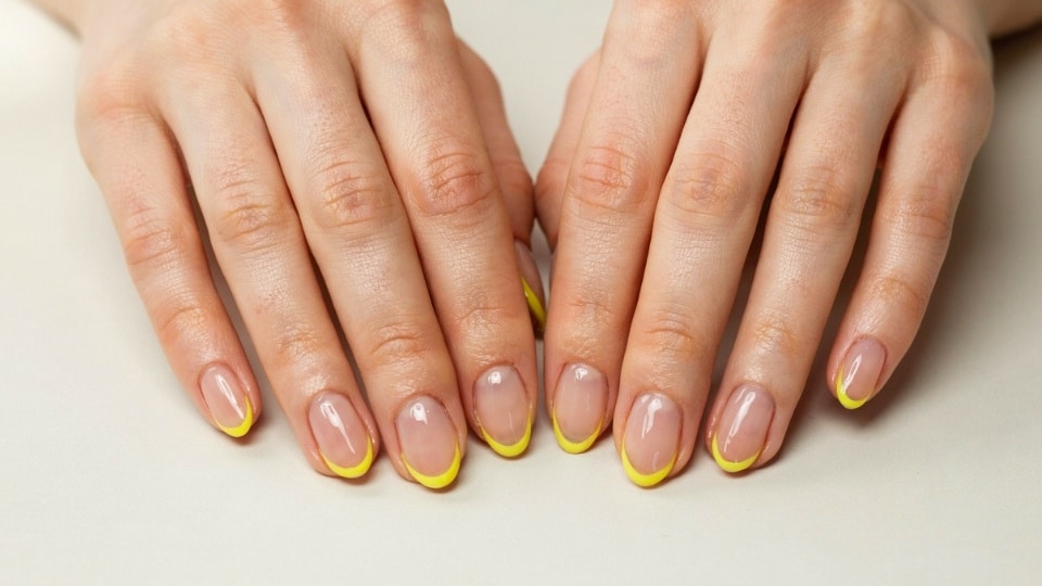 Neon yellow micro French tip nails with a sheer nude base and elegant minimal nail art