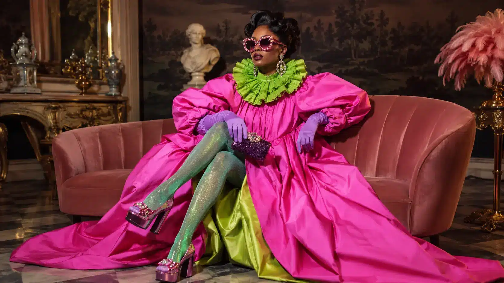 A stylish model wearing a dramatic pink couture outfit with oversized accessories and vibrant colors representing modern camp fashion style