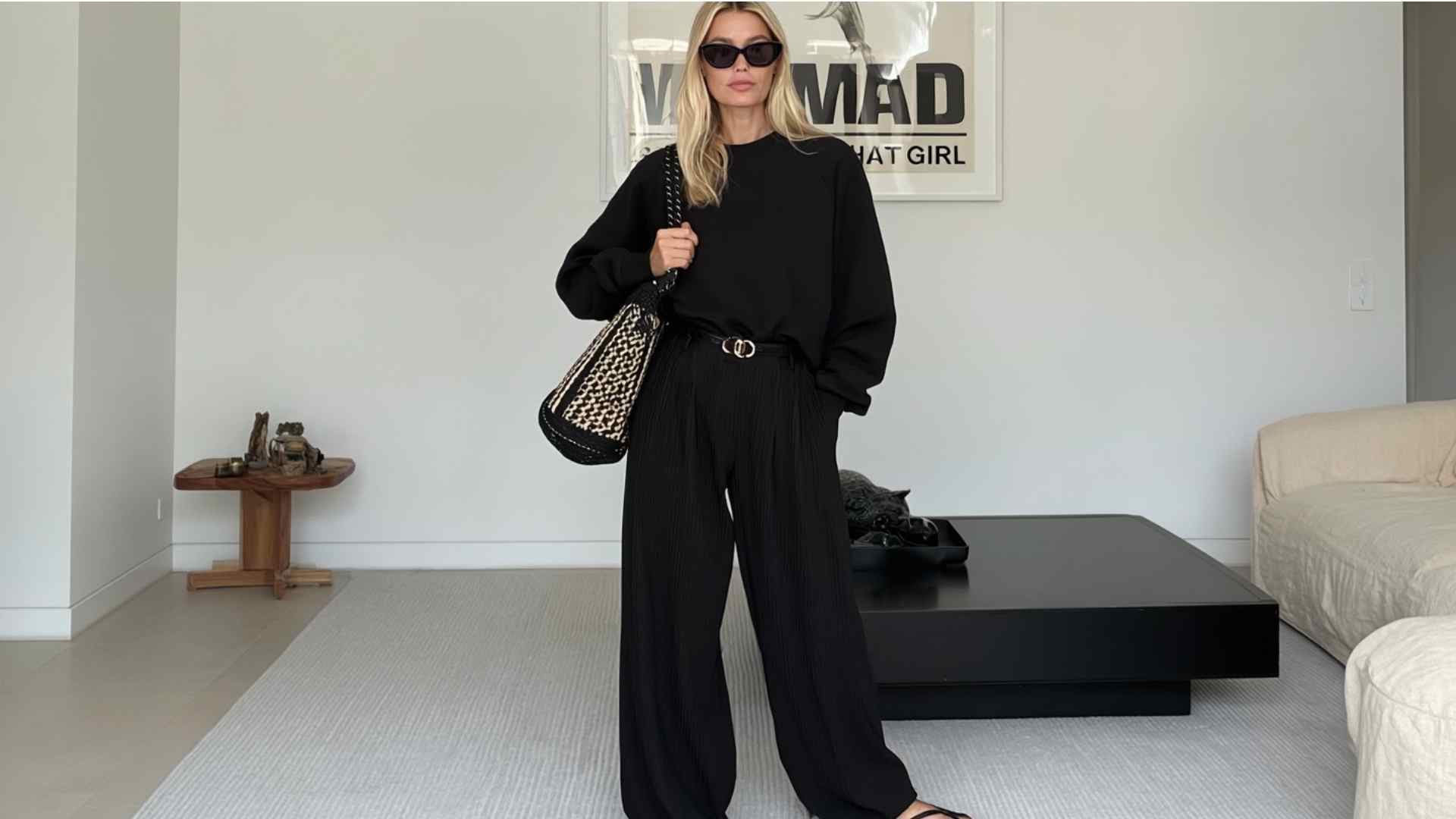 Black monochrome wide leg jeans outfit with a sweater and boots