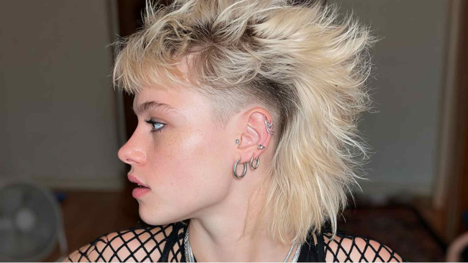 Alternative mullet with closely shaved sides and a longer textured back