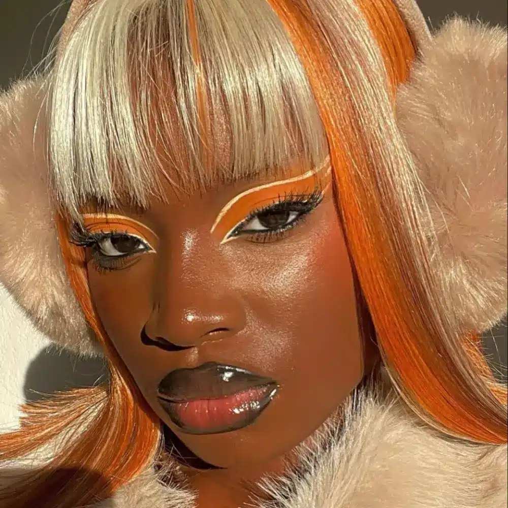Pumpkin spice makeup with warm brown orange eyes, softly bronzed skin, soft brown liner, and a muted nude brown lip