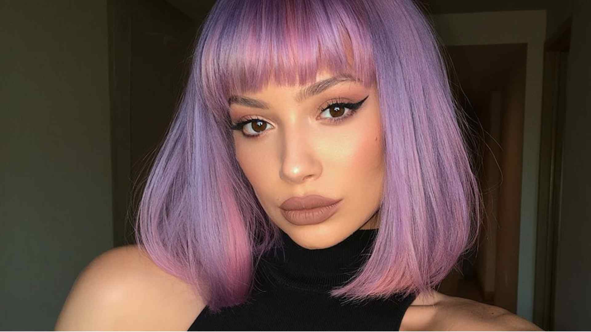 Textured short crop with bold purple bangs as the focal point