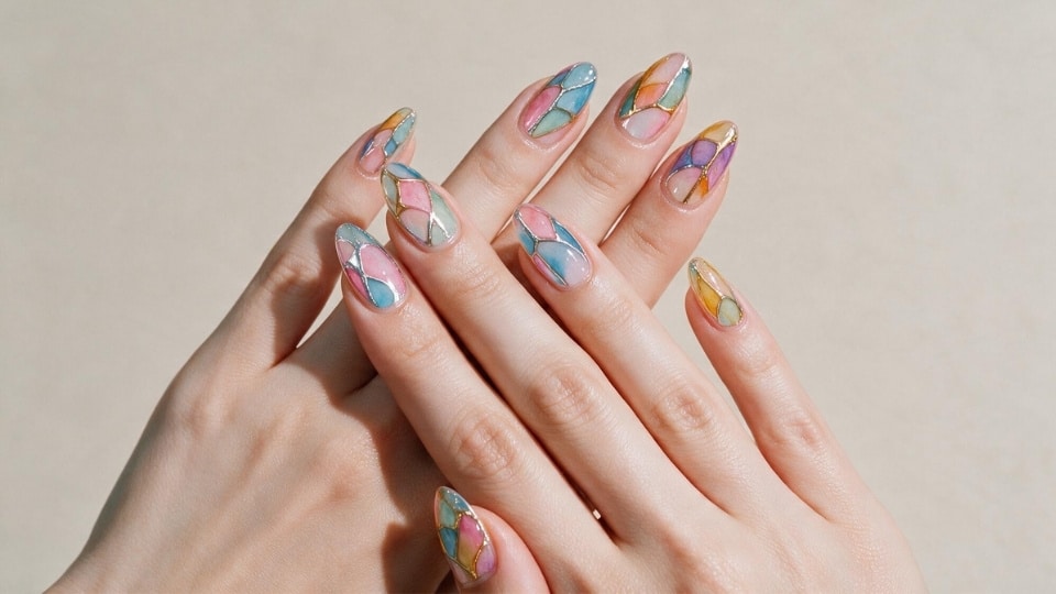 Rainbow glass nails with translucent colorful sections creating a jewel inspired stained glass manicure design
