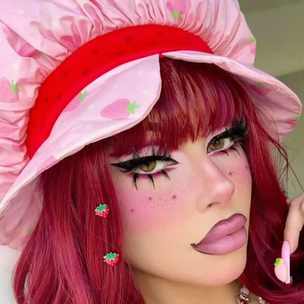 Strawberry Shortcake makeup with dewy skin, rosy pink cheeks, soft red eyeshadow, freckles, and soft berry lip tint