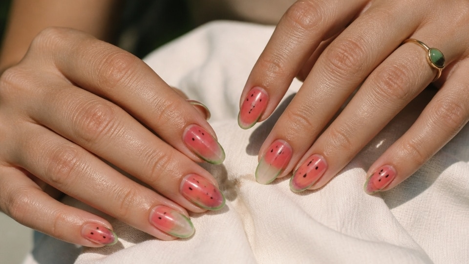 Watermelon jelly nails with translucent pink polish green accents and tiny seed details for a fresh summer look