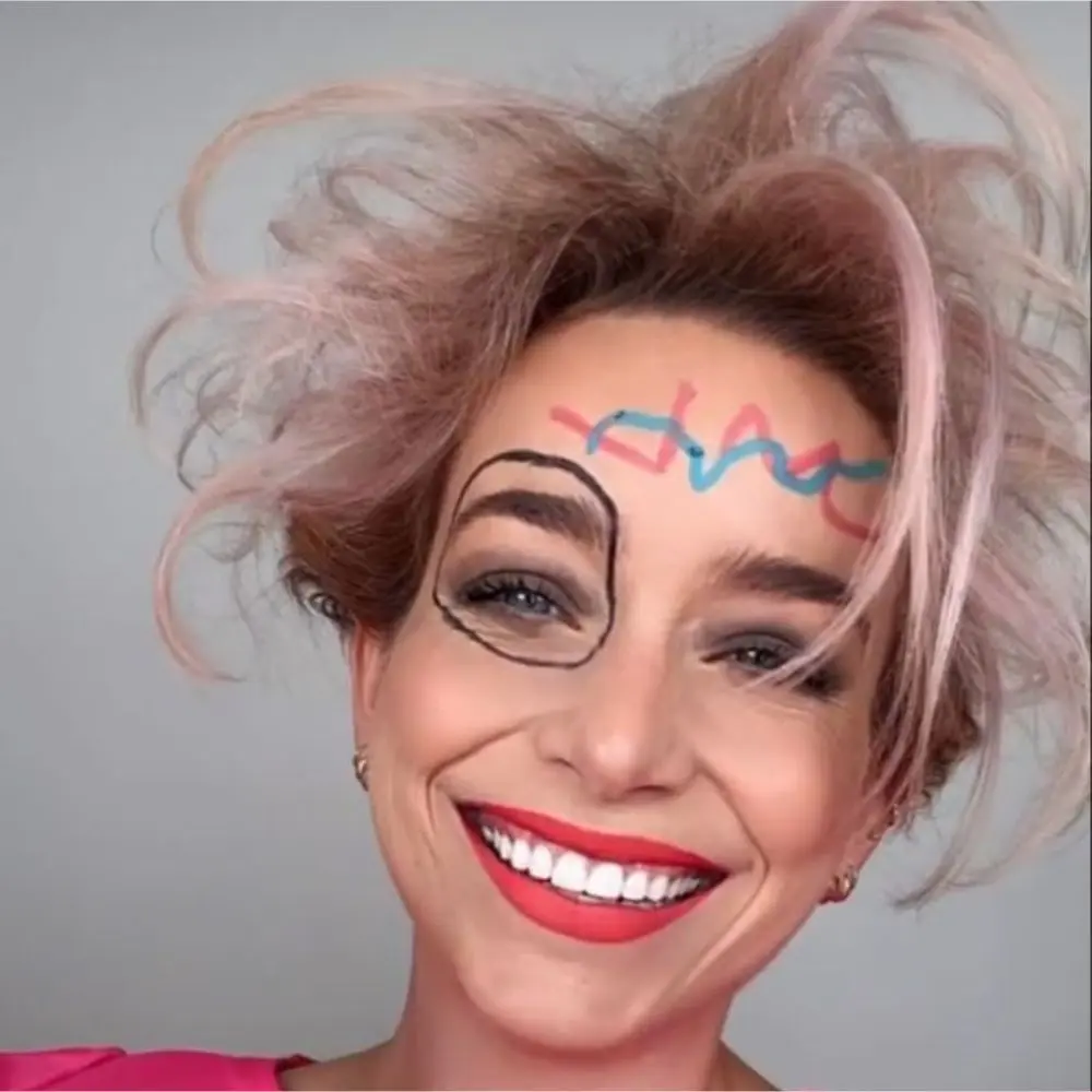Weird Barbie makeup with messy pink shadow, crooked black liner, uneven blush, and rough overdrawn bright pink lips