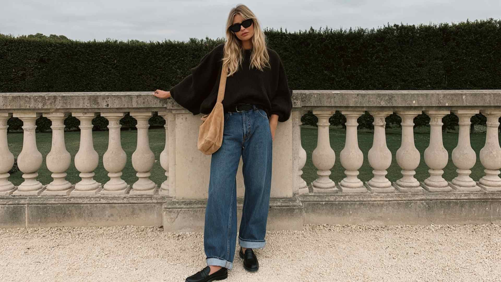 Wide leg jeans with a black sweater and loafers for a chic winter look