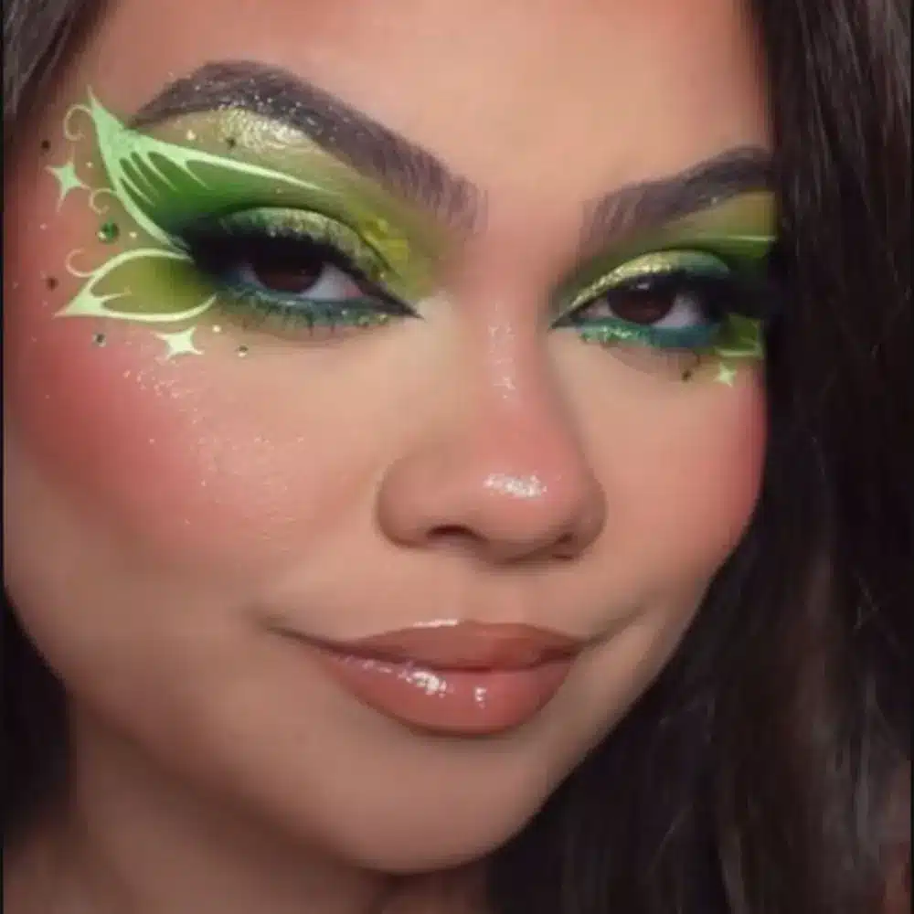 Winx fairy makeup with soft colorful shimmer, glittered inner corners, wide dramatic lashes, and bright glossy lips
